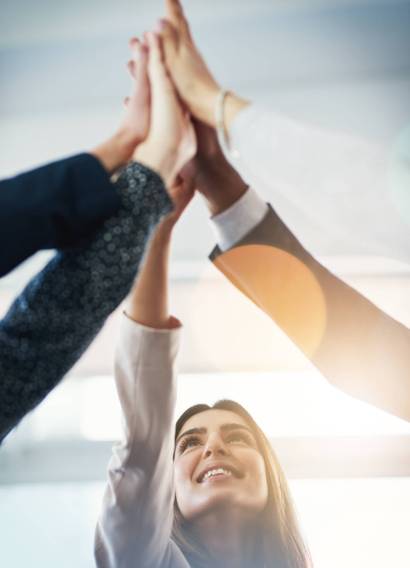 Cropped shot of  group of businesspeople gathering for a high five